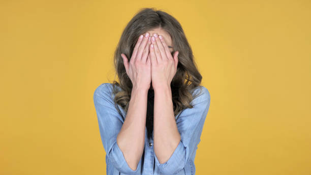istock Hide and Seek, Young Girl Hiding Her Face with Hands 1126412440