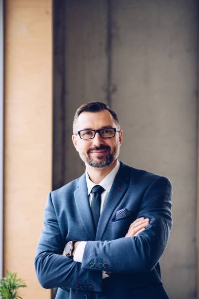 istock Middle aged handsome businessman in suit at office. 1126412509