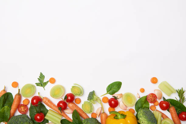 istock Top view of spinach leaves and vegetables on white background 1126412585