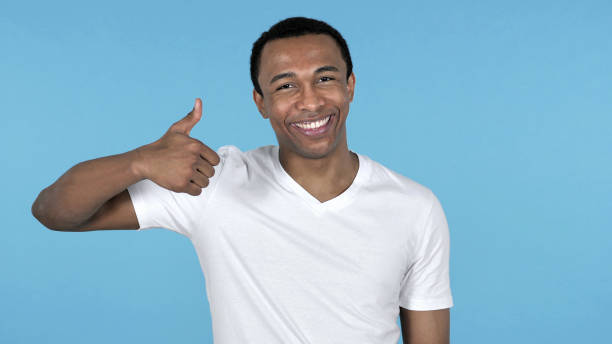 istock African Man Gesturing Thumbs Up Isolated on Blue Background 1126412614