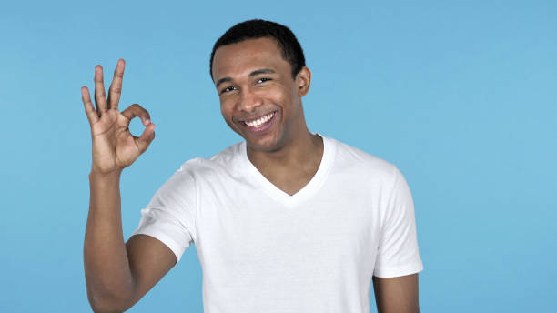 istock Okay Sign by African Man Isolated on Blue Background 1126412637