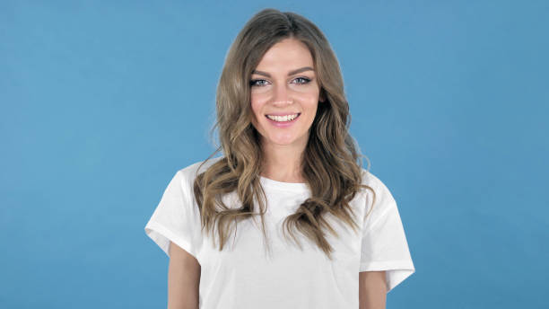 istock Beautiful Smiling Young Girl isolated on Blue Background 1126412641