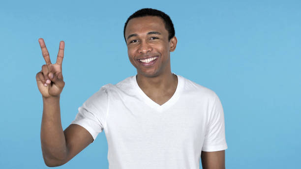 istock Victory Sign by African Man Isolated on Blue Background 1126412642