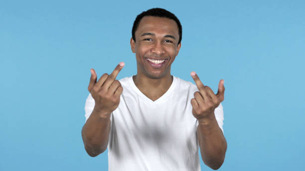 istock Happy African Man Showing Middle Fingers Isolated on Blue Background 1126412719