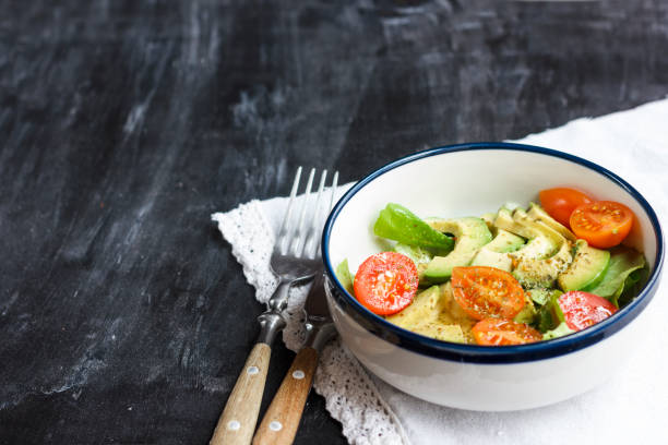 istock Vegetarian salad with avocado, arugula, cherry tomatoes and herbs. 1126414407
