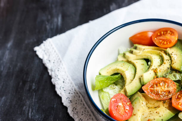 istock Vegetarian salad with avocado, arugula, cherry tomatoes and herbs. 1126415660