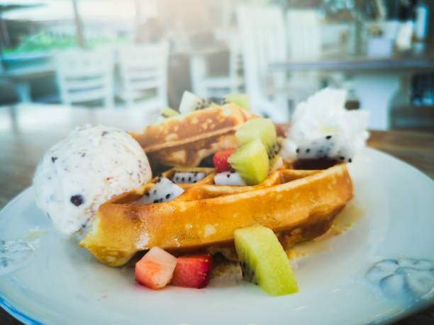 istock Waffles, ice cream, and fruit in a white plate. 1126417457