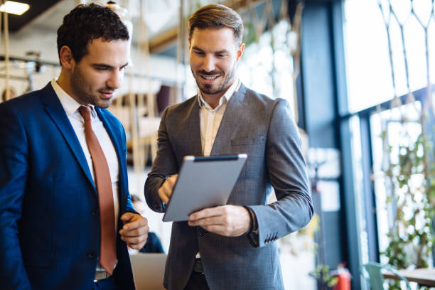 istock Two young businessmen discussing business strategy using digital tablet 1126420268