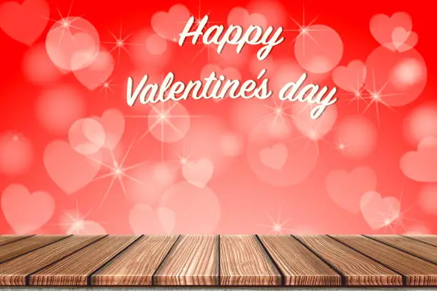 Photo of Empty Wooden board top table in front of blurred red heart background. Perspective wood in blurred bokeh heart valentine day background for photo montage, product display or mock up your product.