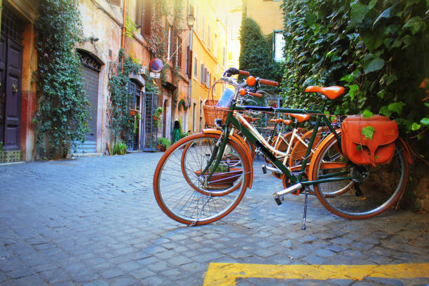 Bicycle standing in front of store on old street of Rome . stock photo