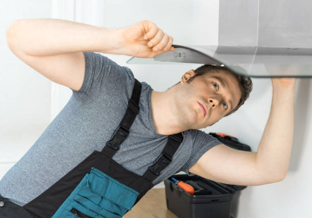 istock Handsome foreman fixing exhaust hood in the kitchen. 1126426772