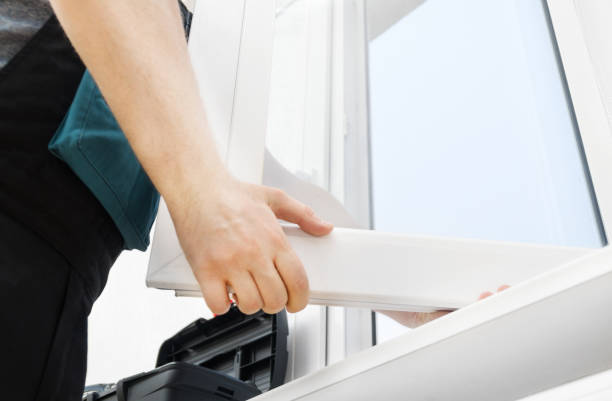 professional handyman installing window at home. - instalar imagens e fotografias de stock