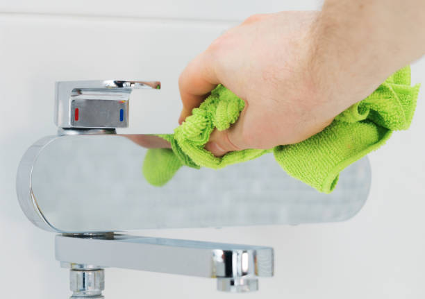 istock House cleaning. Man cleaning tap in bathroom. 1126426925