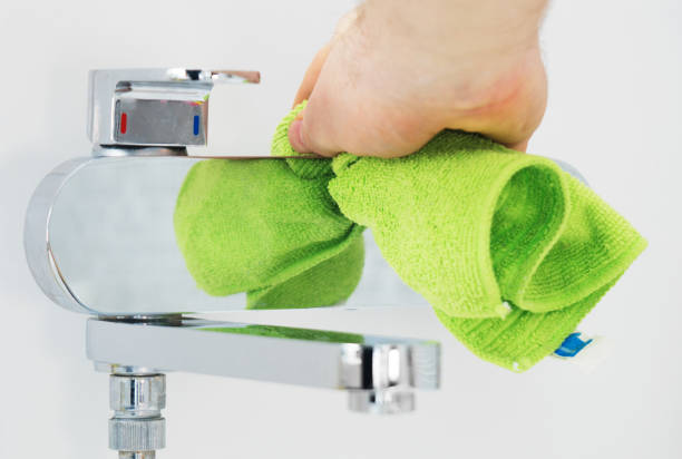 istock House cleaning. Man cleaning tap in bathroom. 1126426927