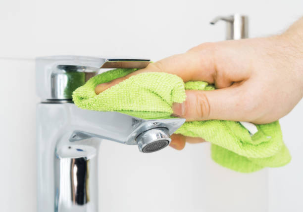 istock House cleaning. Man cleaning tap in bathroom. 1126426931