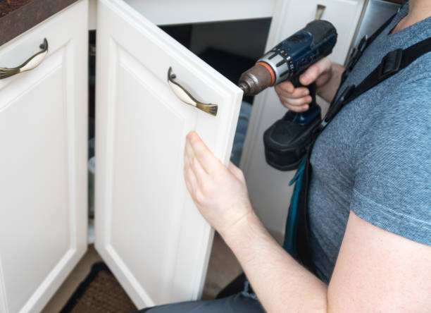 Professional handyman assembling kitchen door cabinet. Professional handyman assembling kitchen door cabinet. kitchen cabinet refacing stock pictures, royalty-free photos & images