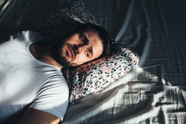 istock Young depressed man crying in bed 1126427813