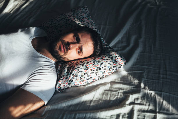 istock Young depressed man crying in bed 1126427816