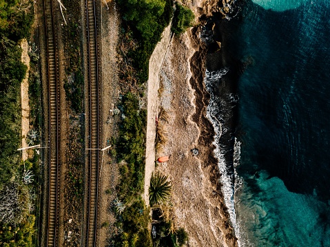 Aerial view of the railway along the sea coast in Italy. Drone photo from above