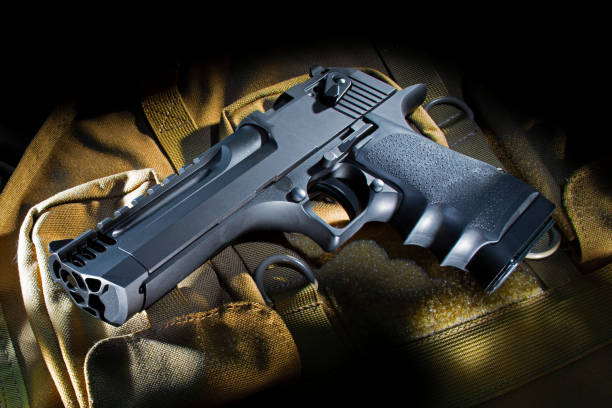istock Semi-automatic handgun on a tan nylon bag 1126428424