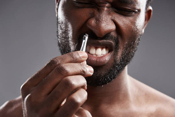 istock Irritated young afro American man holding forcepts 1126428869