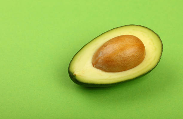 istock Close-Up Of Avocado On Green Background 1126429118