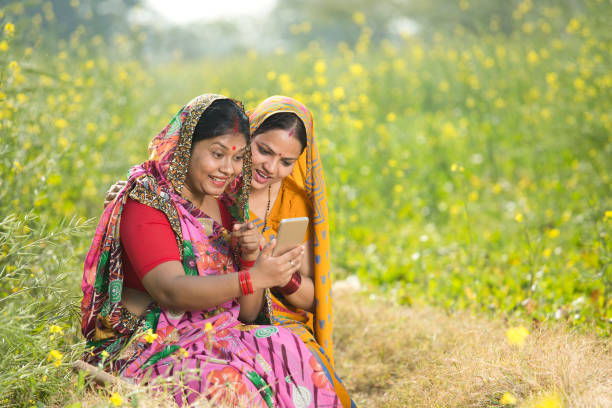 istock Rural women using mobile phone in agricultural field 1126429928