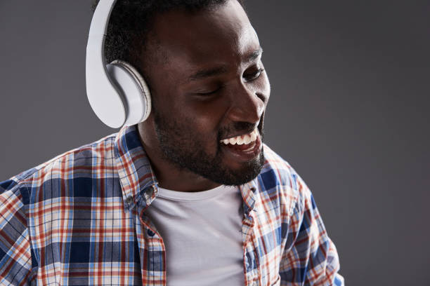 istock Close up of a smiling afro american man using headphones 1126430546