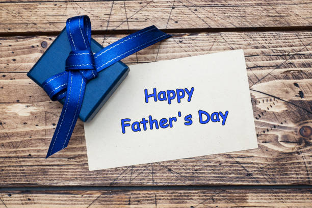 istock Blue gift box with ribbons and space for text on wooden table. Father's Day Concept. 1126432301