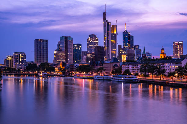 istock Frankfurt am Main - Skyline banking district at sunset with purple hues 1126433842