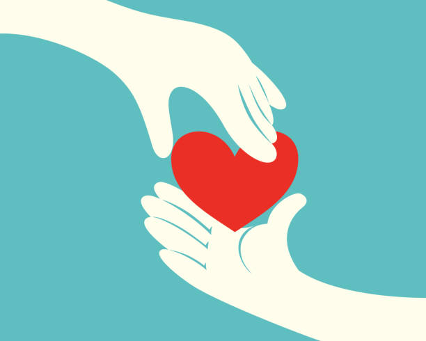 Hand giving a red heart to another hand Close up of hand giving a red heart to another hand on green background handing out stock illustrations