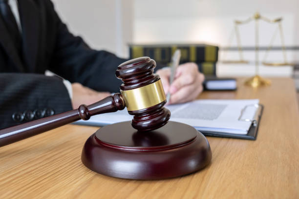 istock Midsection Of Lawyer Reading Paper While Sitting At Desk In Office 1126438604