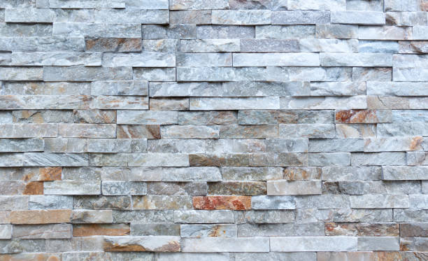 istock Stone wall of rough elongated facing stones 1126438644