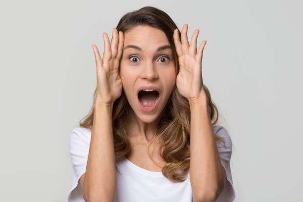 istock Amazed surprised woman feeling excited screaming looking at camera 1126440341