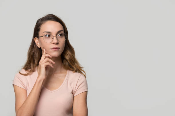 istock Thoughtful doubtful woman looking at copyspace uncertain isolated on background 1126440394