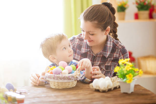 istock A mother and her son painting Easter eggs. Happy family preparing for Easter. Happy easter. 1126442055