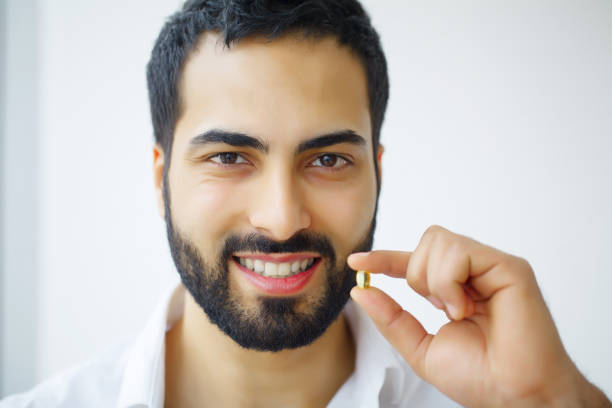 istock Beautiful Man Taking Pill, Medicine. Vitamins And Supplements 1126442756