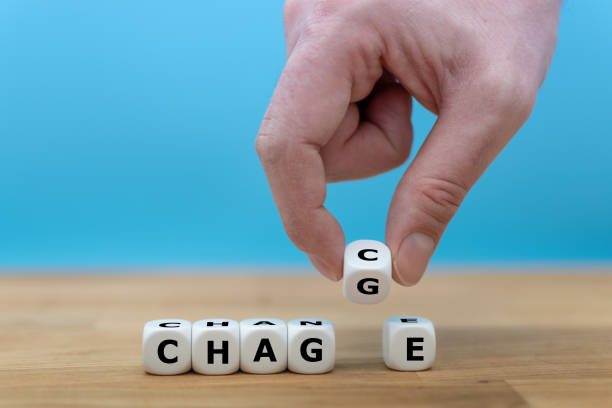istock Hand turns a dice and changes the word 