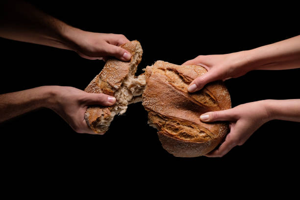 istock Human hands tearing the loaf of bread 1126443625