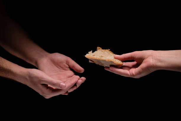istock Woman hands giving chunk of bread 1126443638