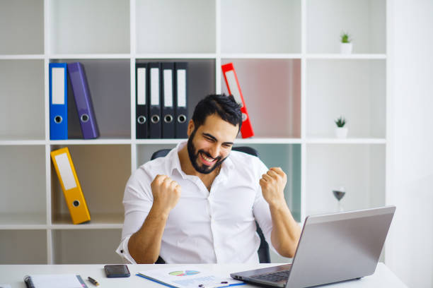 istock Happy successful businessman in a modern startup office indoors 1126443708