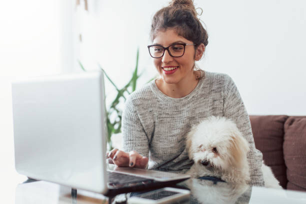 istock Woman working at home and hugging her puppy 1126443893