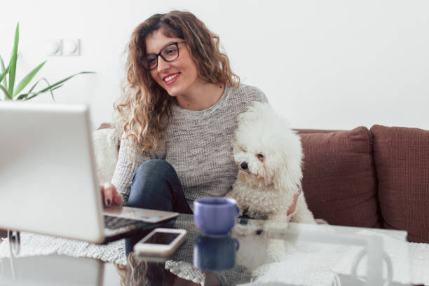 istock Woman working at home and hugging her puppy 1126443991