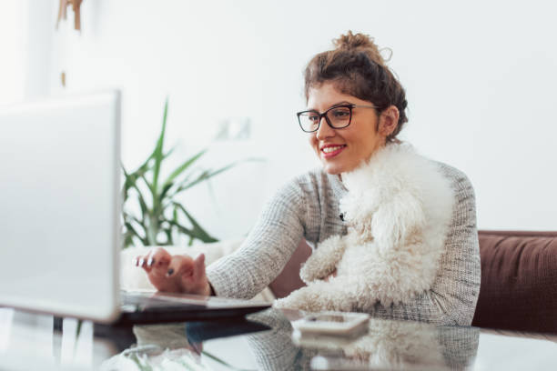 istock Woman working at home and hugging her puppy 1126443993
