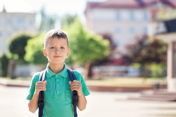 istock Child with school bag. Kid outdoors. Back to school concept 1126444337