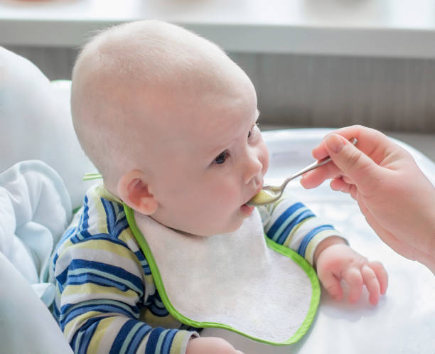 istock Baby fed with a spoon 1126444562