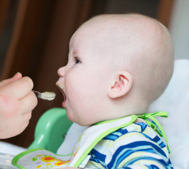 istock Baby fed with a spoon 1126444587