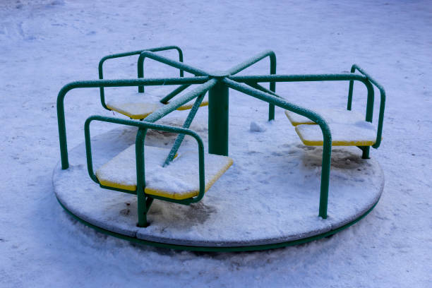 istock Snowy children's roundabout green 1126445308