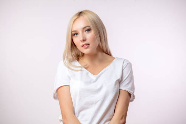 istock serious woman in blond wig on the white background 1126449387