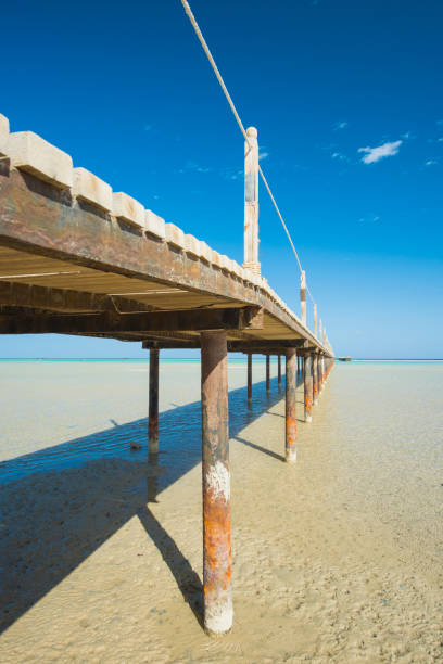 istock Wooden pier from beach on tropical sea 1126451148